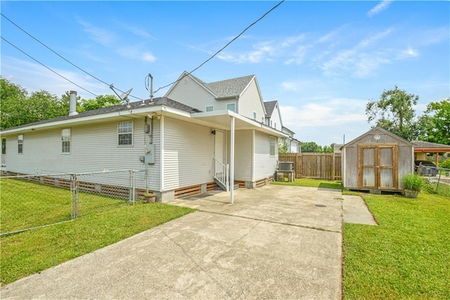 1401 Claiborne Dr, Jefferson, LA 70121 - view of home's exterior with a fenced backyard, a storage shed, driveway, and a shingled roof