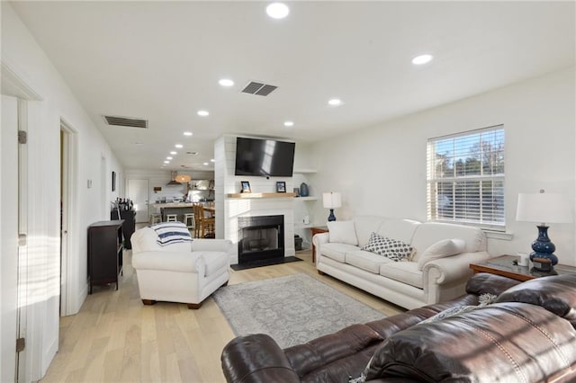 1401 Claiborne Dr, Jefferson, LA 70121 - living room featuring light wood-type flooring, a fireplace with flush hearth, and recessed lighting