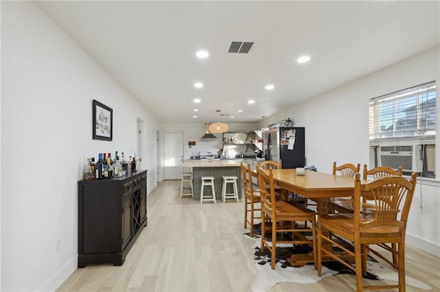 1401 Claiborne Dr, Jefferson, LA 70121 - dining area with recessed lighting, light wood-style flooring, a bar, baseboards, and cooling unit