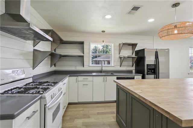1401 Claiborne Dr, Jefferson, LA 70121 - kitchen featuring white range with gas stovetop, stainless steel fridge with ice dispenser, wood counters, open shelves, and a sink