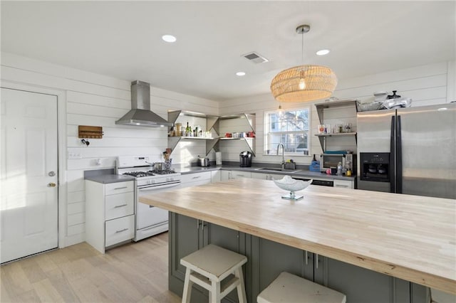 1401 Claiborne Dr, Jefferson, LA 70121 - kitchen with wooden counters, white gas range, stainless steel refrigerator with ice dispenser, open shelves, and recessed lighting