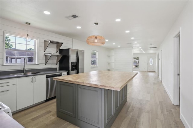 1401 Claiborne Dr, Jefferson, LA 70121 - kitchen with appliances with stainless steel finishes, a sink, light wood-type flooring, wooden counters, and recessed lighting