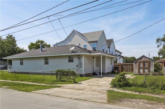1401 Claiborne Dr, Jefferson, LA 70121 - view of front of property with a storage shed, entry steps, fence, an outbuilding, and concrete driveway