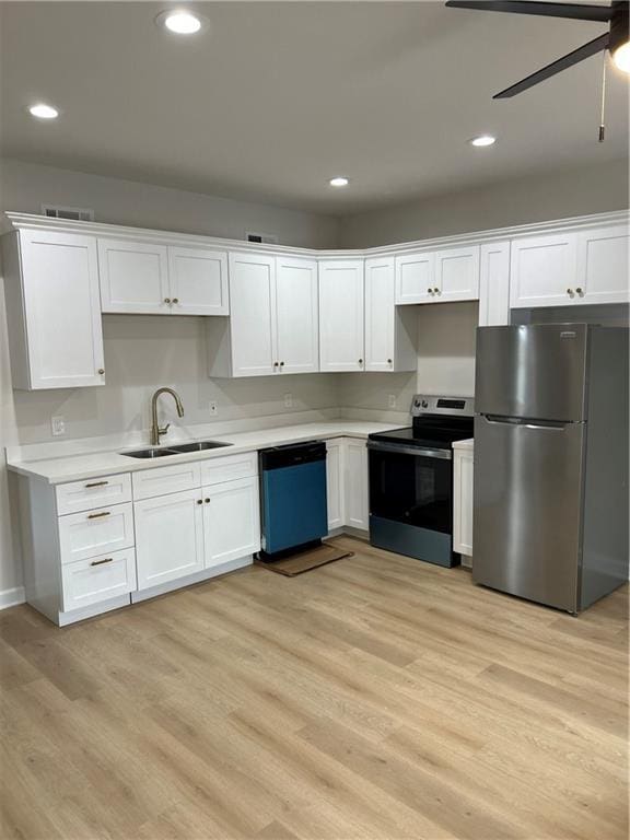 340606 Jackson Ave, New Orleans, LA 70125 - kitchen with stainless steel appliances, a sink, white cabinetry, light countertops, and recessed lighting