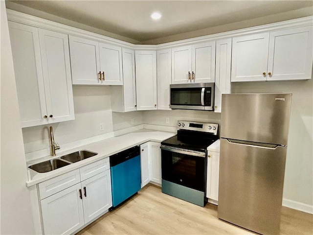 340606 Jackson Ave, New Orleans, LA 70125 - kitchen with stainless steel appliances, a sink, white cabinets, and recessed lighting