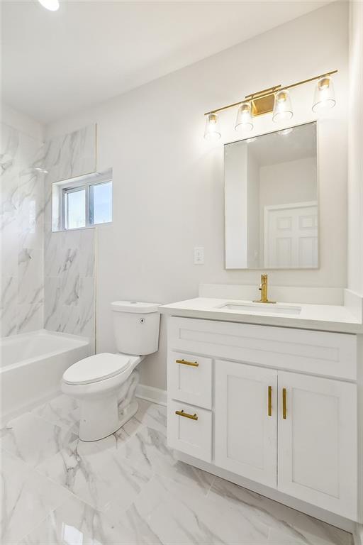 340606 Jackson Ave, New Orleans, LA 70125 - bathroom with marble finish floors, vanity, toilet, and  shower combination