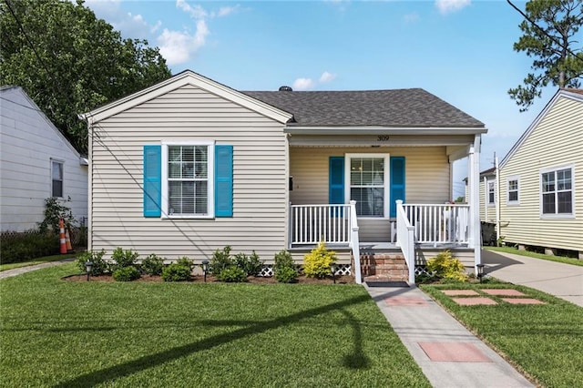 309 Wallace Dr, New Orleans, LA 70122 - bungalow featuring covered porch, a front lawn, and a shingled roof