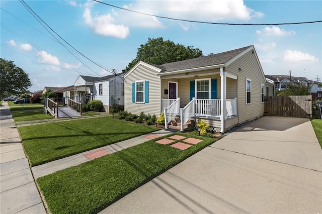 309 Wallace Dr, New Orleans, LA 70122 - view of front of property with covered porch, driveway, a residential view, and a shingled roof