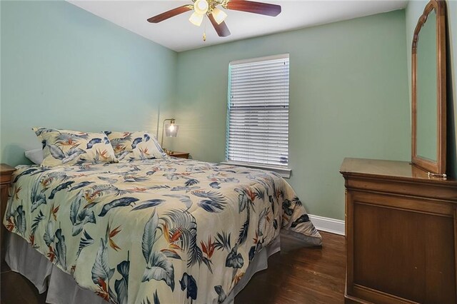 309 Wallace Dr, New Orleans, LA 70122 - bedroom with dark wood finished floors, baseboards, and ceiling fan