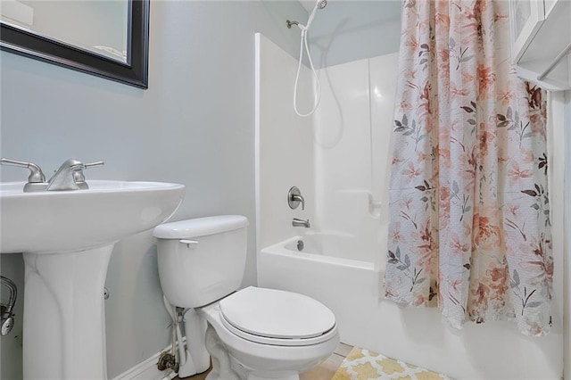 309 Wallace Dr, New Orleans, LA 70122 - full bathroom featuring shower / tub combo, toilet, tile patterned flooring, and baseboards