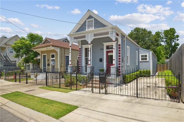 4119 S Liberty St, New Orleans, LA 70115 - shotgun-style home featuring a fenced front yard and a porch