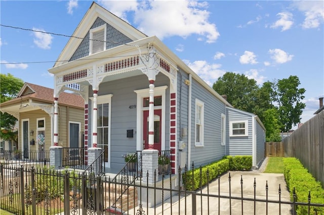4119 S Liberty St, New Orleans, LA 70115 - view of front of house with covered porch and a fenced front yard