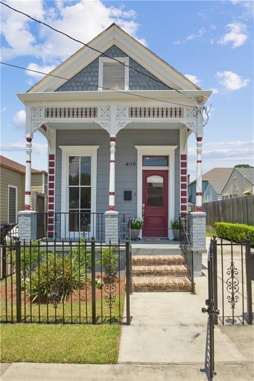 4119 S Liberty St, New Orleans, LA 70115 - view of front of property featuring a porch, a fenced front yard, and a gate