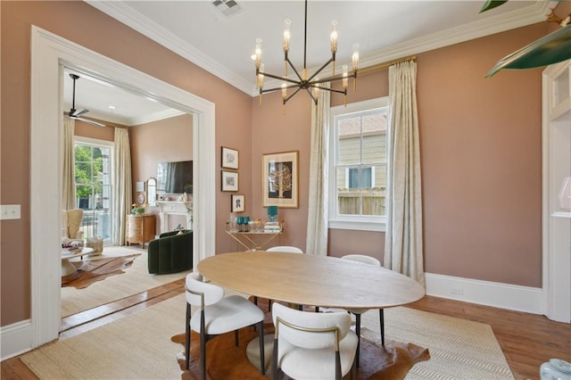 4119 S Liberty St, New Orleans, LA 70115 - dining room featuring a chandelier, wood finished floors, baseboards, and ornamental molding