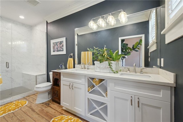 4119 S Liberty St, New Orleans, LA 70115 - full bath with wood finished floors, ornamental molding, toilet, a stall shower, and double vanity