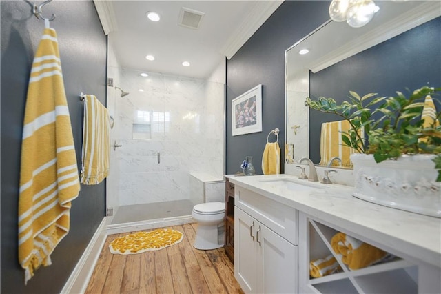 4119 S Liberty St, New Orleans, LA 70115 - bathroom featuring ornamental molding, wood finished floors, toilet, a stall shower, and vanity