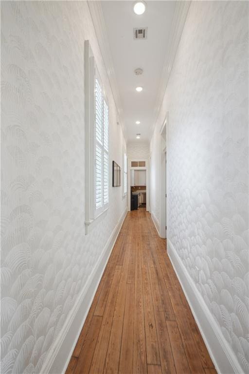 4119 S Liberty St, New Orleans, LA 70115 - corridor with wood-type flooring, baseboards, and crown molding