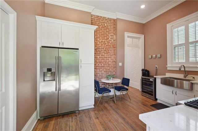 4119 S Liberty St, New Orleans, LA 70115 - kitchen featuring high end refrigerator, wine cooler, a sink, dark wood-style floors, and white cabinets