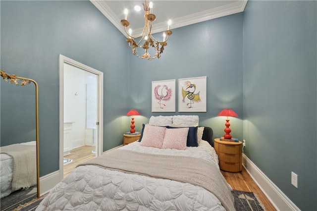 4119 S Liberty St, New Orleans, LA 70115 - bedroom featuring wood finished floors, crown molding, a chandelier, ensuite bathroom, and baseboards