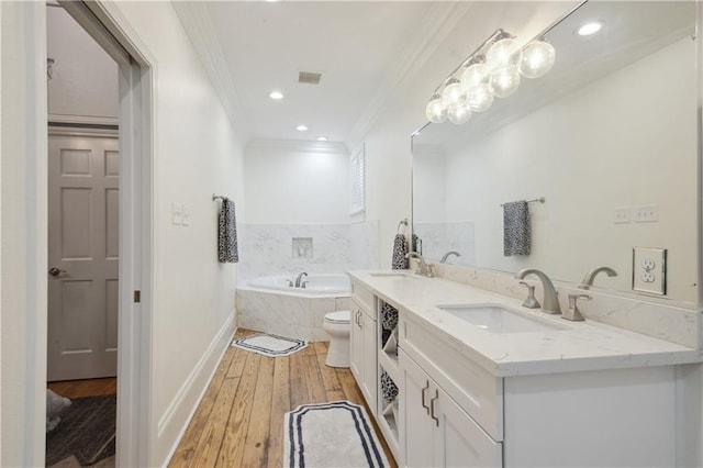 4119 S Liberty St, New Orleans, LA 70115 - full bathroom featuring ornamental molding, wood-type flooring, a garden tub, double vanity, and baseboards