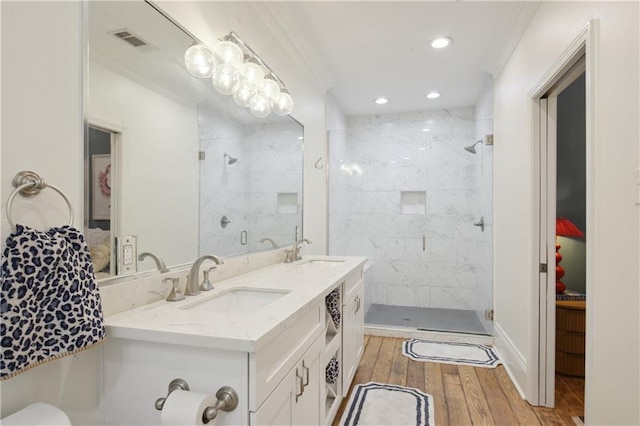 4119 S Liberty St, New Orleans, LA 70115 - bathroom with a stall shower, hardwood / wood-style floors, ornamental molding, recessed lighting, and double vanity