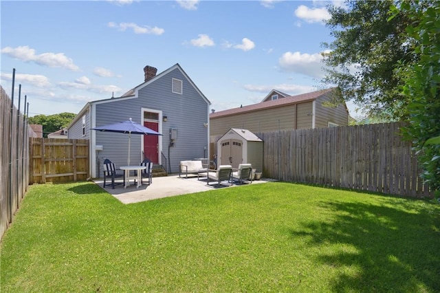 4119 S Liberty St, New Orleans, LA 70115 - rear view of house featuring a storage unit, a patio, a chimney, and an outbuilding