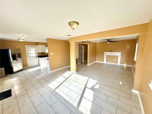 1523 W Dr, Westwego, LA 70094 - unfurnished living room featuring ceiling fan and baseboards