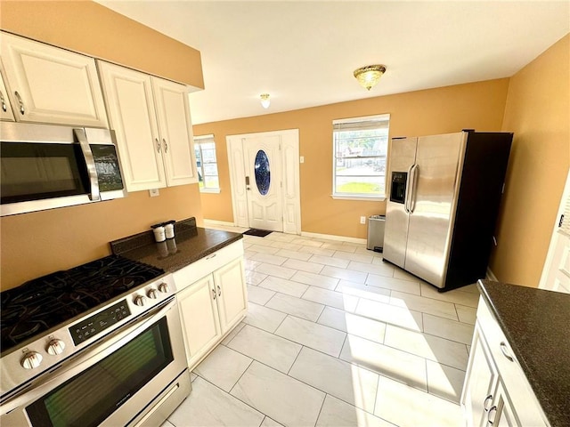 1523 W Dr, Westwego, LA 70094 - kitchen featuring appliances with stainless steel finishes, dark countertops, and white cabinets