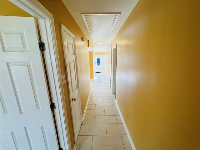 1523 W Dr, Westwego, LA 70094 - hallway featuring attic access, baseboards, and light tile patterned flooring