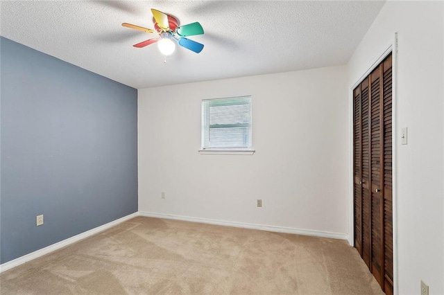 1508 Apple St, Metairie, LA 70001 - unfurnished bedroom featuring light colored carpet, a closet, a textured ceiling, baseboards, and ceiling fan