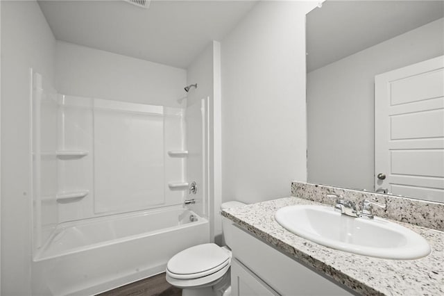full bathroom featuring toilet, vanity, and washtub / shower combination