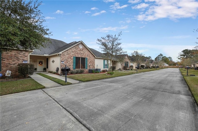 40145 Taylor Trl Unit 503, Slidell, LA 70461 - view of front of house with a front yard, concrete driveway, and a residential view