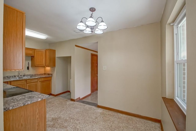 3233 Duncan St, Slidell, LA 70458 - kitchen with a sink, a chandelier, plenty of natural light, and baseboards