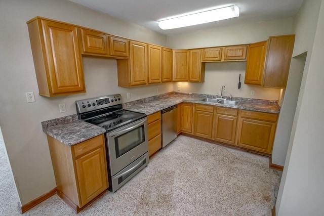 3233 Duncan St, Slidell, LA 70458 - kitchen with appliances with stainless steel finishes, a sink, light colored carpet, dark countertops, and baseboards