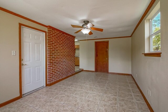 3233 Duncan St, Slidell, LA 70458 - spare room featuring ceiling fan, baseboards, ornamental molding, and light tile patterned flooring