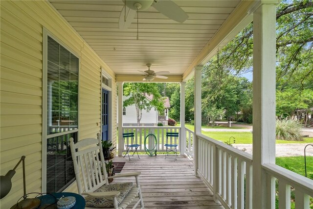 22236 8th St, Abita Springs, LA 70420 - wooden porch featuring a ceiling fan and a yard