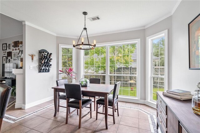 22236 8th St, Abita Springs, LA 70420 - dining area with light tile patterned floors, a chandelier, and ornamental molding