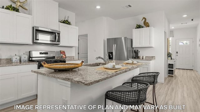 311 Holmes Blvd, Terrytown, LA 70056 - kitchen featuring stainless steel appliances, a sink, light wood-type flooring, white cabinets, and recessed lighting