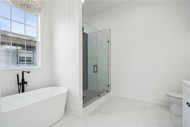 5519 Wingate Dr, New Orleans, LA 70122 - bathroom featuring marble look tiles, a freestanding tub, a stall shower, vanity, and a chandelier