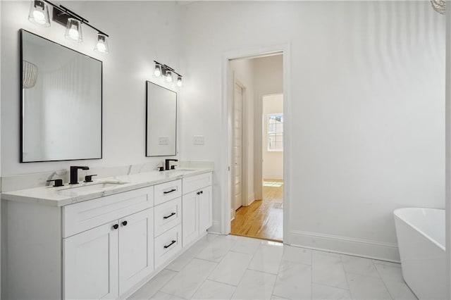 5519 Wingate Dr, New Orleans, LA 70122 - full bathroom with marble look tile flooring, double vanity, and a freestanding tub
