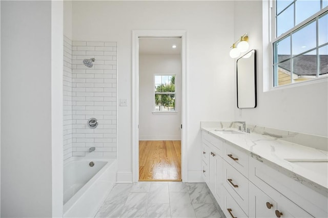 5519 Wingate Dr, New Orleans, LA 70122 - full bathroom with double vanity, marble finish floors, and tub / shower combination