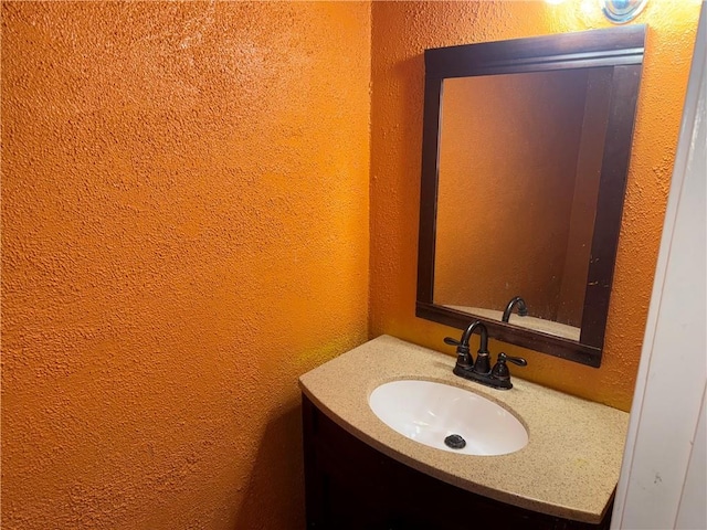 5140 Bayouview Ct Unit 1, New Orleans, LA 70126 - bathroom featuring a textured wall and vanity