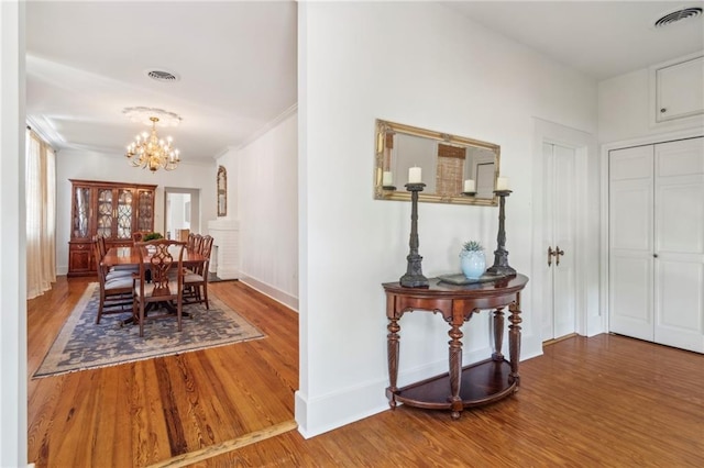 317 Henry Clay Ave, New Orleans, LA 70118 - dining area with wood finished floors, a chandelier, and baseboards