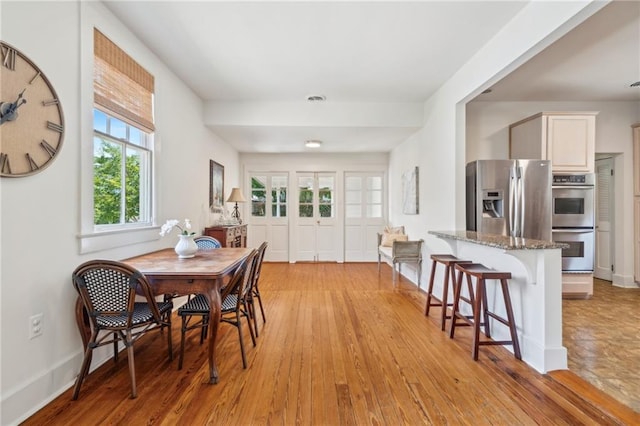 317 Henry Clay Ave, New Orleans, LA 70118 - dining room with light wood-style floors and baseboards