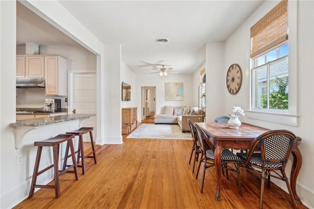 317 Henry Clay Ave, New Orleans, LA 70118 - dining room featuring light wood-type flooring, ceiling fan, and baseboards