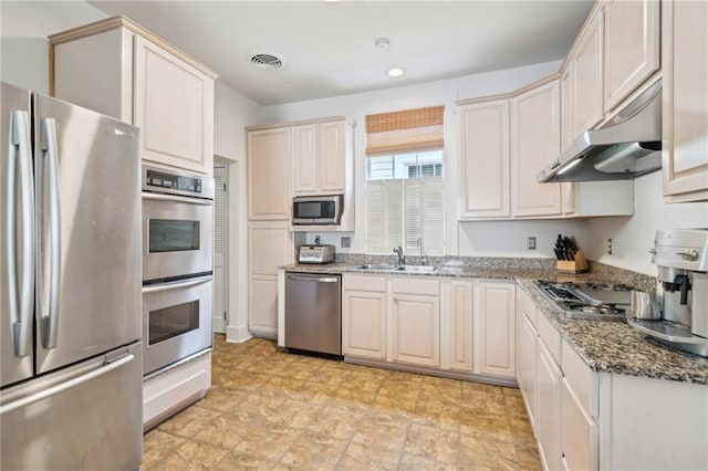 317 Henry Clay Ave, New Orleans, LA 70118 - kitchen with appliances with stainless steel finishes, under cabinet range hood, a sink, and stone countertops