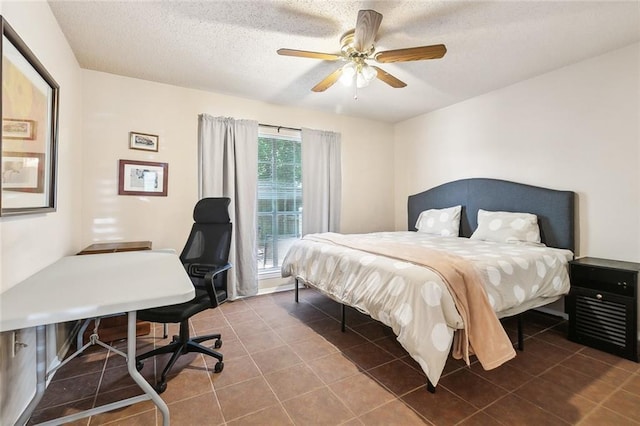 tiled bedroom with a textured ceiling, a ceiling fan, and a desk