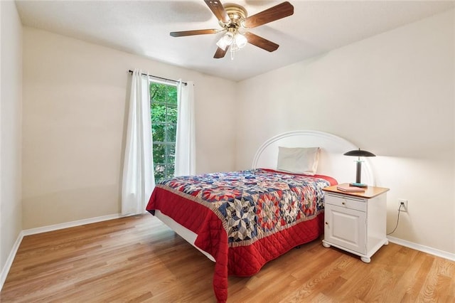 bedroom with light wood-type flooring, baseboards, and a ceiling fan
