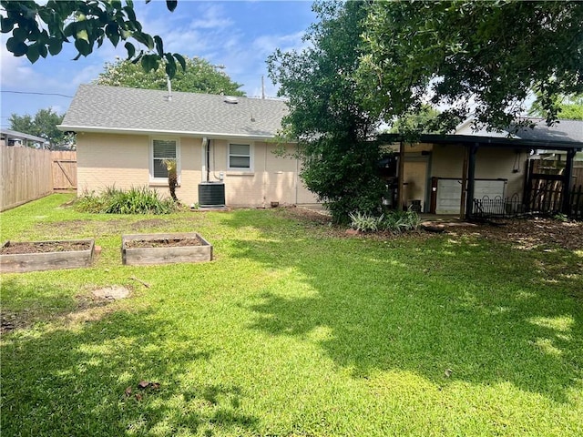 817 N Sibley St, Metairie, LA 70003 - back of house featuring a garden, central AC unit, brick siding, and a shingled roof