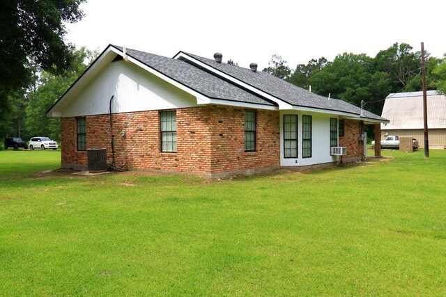 42073 Farlow Ln, Ponchatoula, LA 70454 - back of property featuring a yard, brick siding, central AC, and roof with shingles